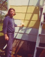 Joe puts on paint with a paint pad.